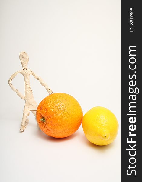 Figure of paper man with lemon and orange. Figure of paper man with lemon and orange