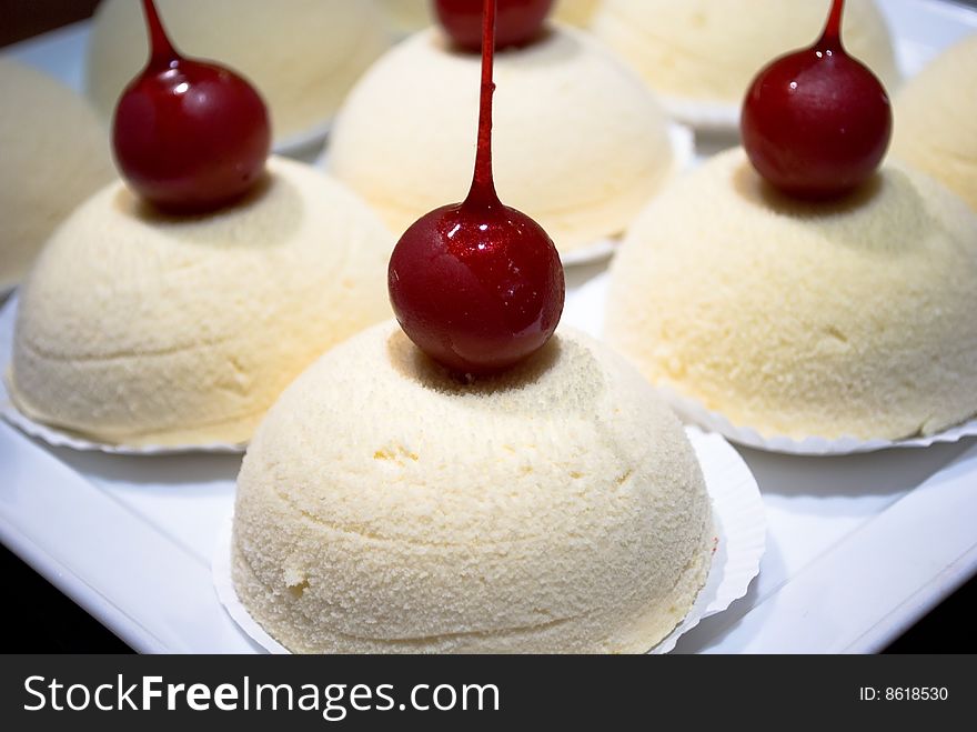 Beautiful white cakes with cherry