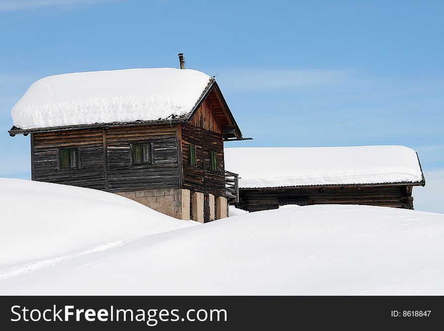 A mountain landscape with a chalet in the snow. A mountain landscape with a chalet in the snow.