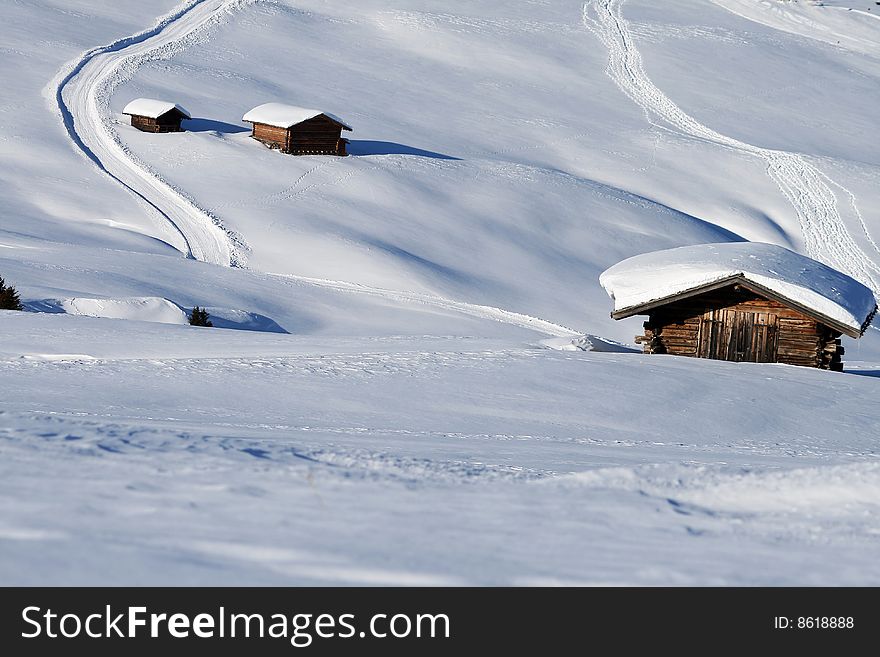 A mountain landscape with a chalet in the snow. A mountain landscape with a chalet in the snow.