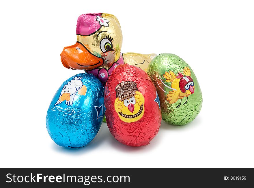 Chocolate chicken and three easter chocolate eggs on white background. Chocolate chicken and three easter chocolate eggs on white background
