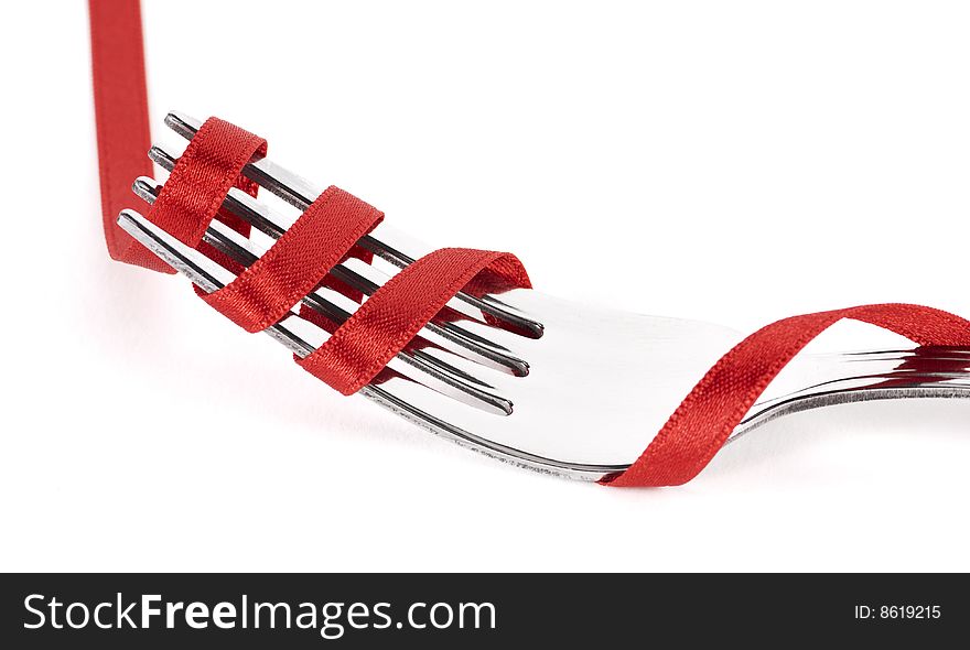 Fork with red ribbon threaded. Fork with red ribbon threaded