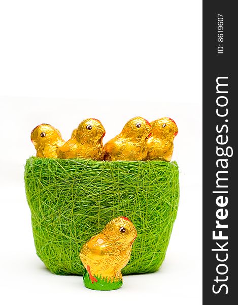 Easter chocolate chickens in grass-tidy, isolated