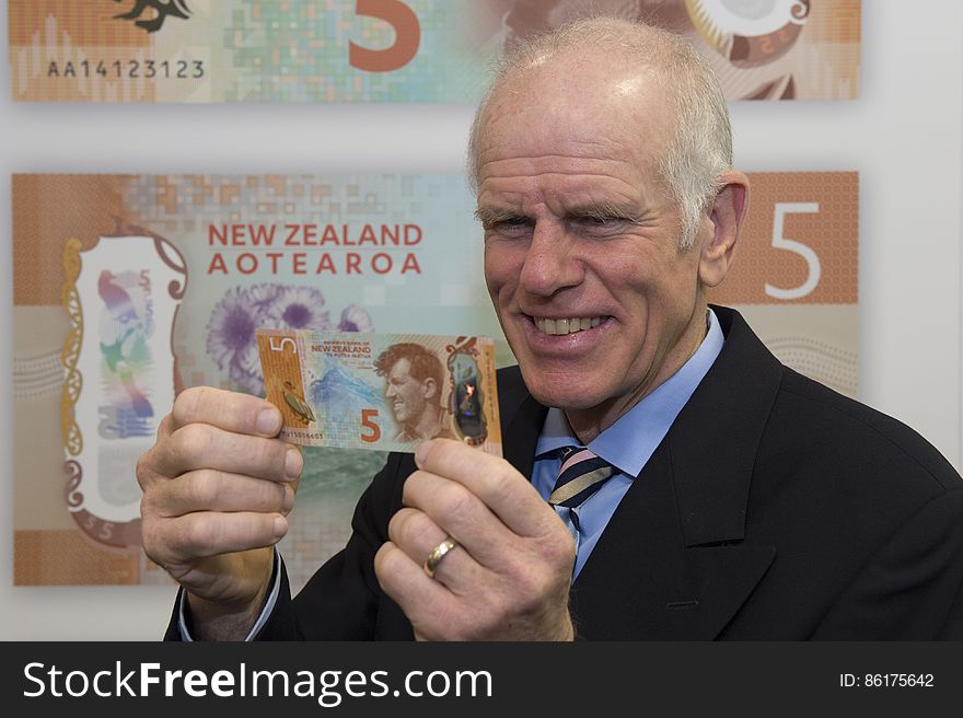Peter Hillary holding the new $5 note featuring Sir Edmund Hillary
