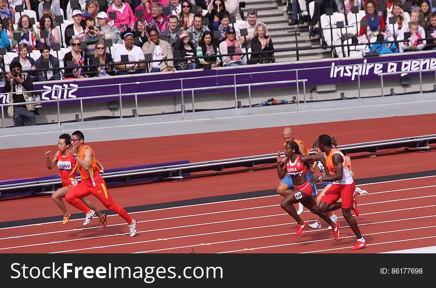 Guohua Zhou of China and her guide Jie LI pulling ahead in the Women&#x27;s 100m T12 Heat 5 during the Paralympics London 2012 Games