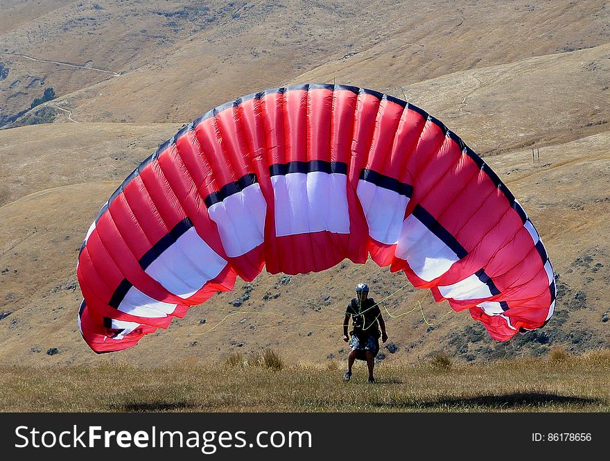 Paragliding is the recreational and competitive adventure sport of flying paragliders: lightweight, free-flying, foot-launched glider aircraft with no rigid primary structure.The pilot sits in a harness suspended below a fabric wing comprising a large number of interconnected baffled cells. Wing shape is maintained by the suspension lines, the pressure of air entering vents in the front of the wing, and the aerodynamic forces of the air flowing over the outside. Despite not using an engine, paraglider flights can last many hours and cover many hundreds of kilometers, though flights of one to two hours and covering some tens of kilometers are more the norm. By skilful exploitation of sources of lift, the pilot may gain height, often climbing to altitudes of a few thousand meters. Paragliding is the recreational and competitive adventure sport of flying paragliders: lightweight, free-flying, foot-launched glider aircraft with no rigid primary structure.The pilot sits in a harness suspended below a fabric wing comprising a large number of interconnected baffled cells. Wing shape is maintained by the suspension lines, the pressure of air entering vents in the front of the wing, and the aerodynamic forces of the air flowing over the outside. Despite not using an engine, paraglider flights can last many hours and cover many hundreds of kilometers, though flights of one to two hours and covering some tens of kilometers are more the norm. By skilful exploitation of sources of lift, the pilot may gain height, often climbing to altitudes of a few thousand meters.