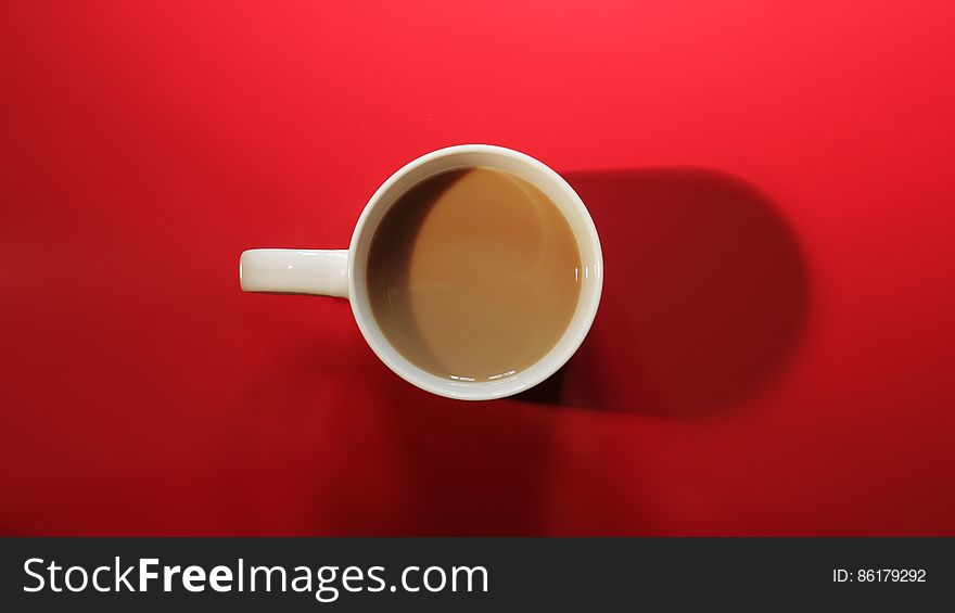 Coffee Cup With Coffee On Red Background
