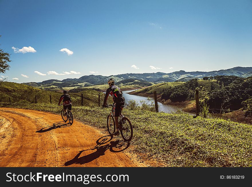 Bicyclist Passing the Road Near the River