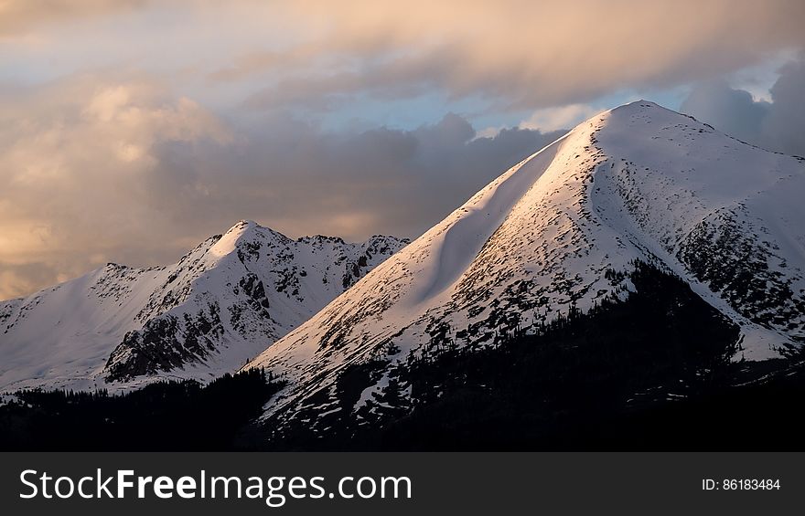 Mountain With Snow Under Cloudy Skies