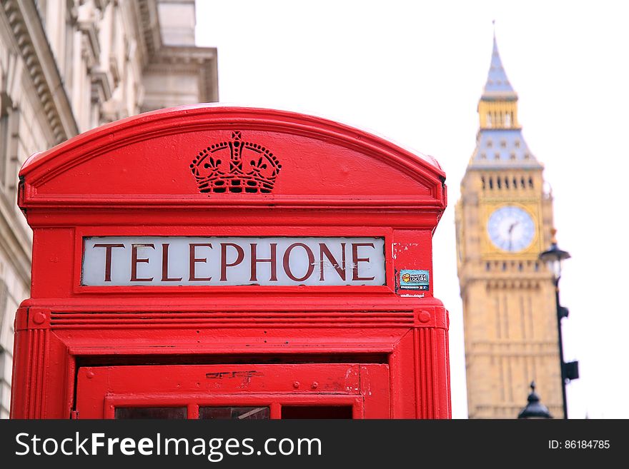 Closeup of red telephone box with Big Ben clock tower in background, London, England. Closeup of red telephone box with Big Ben clock tower in background, London, England.