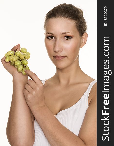 Pretty young woman enjoying fresh grapes