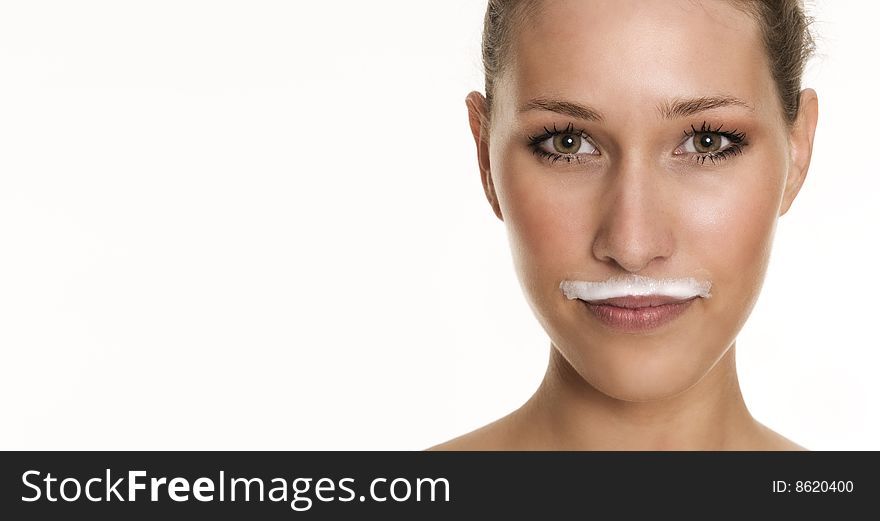 Pretty womans face with a milky beard over her lips