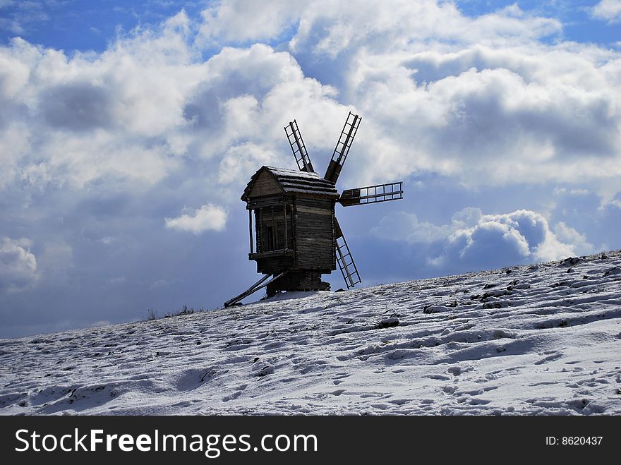 Old abandoned windmill with blue sky in background
