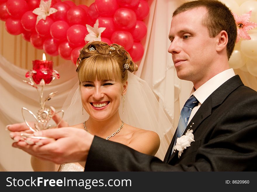 Young bride and bridegroom with candle. Young bride and bridegroom with candle