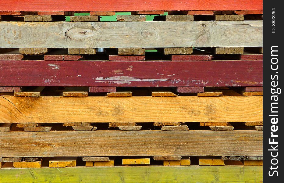 Close-up image of a stack of colorful wooden pallets. Close-up image of a stack of colorful wooden pallets.