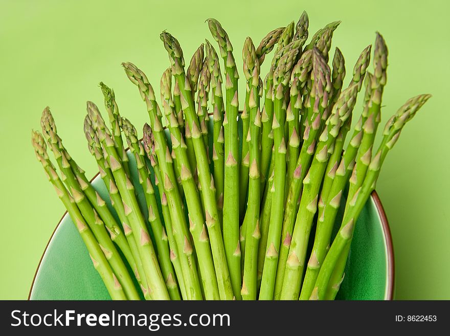 Lovely Asparagus in a bowl on Green