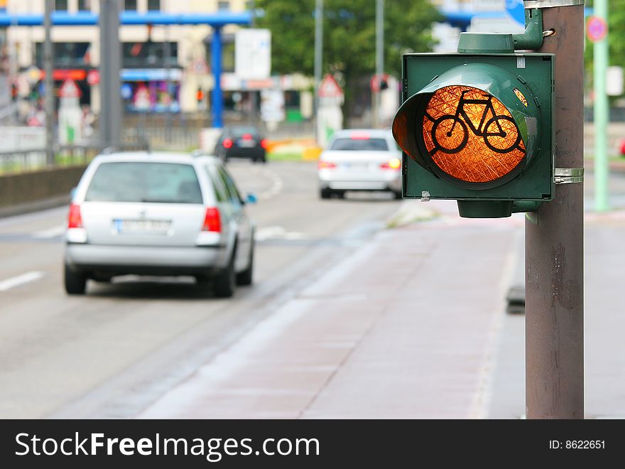 Bicycle roadsign on the street with cars
