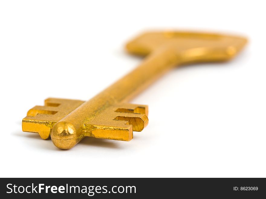 Macro of retro gold key isolated on white background