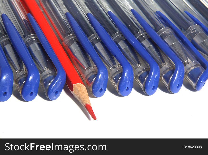 Many writing handles of dark blue color and one red pencil. Many writing handles of dark blue color and one red pencil.