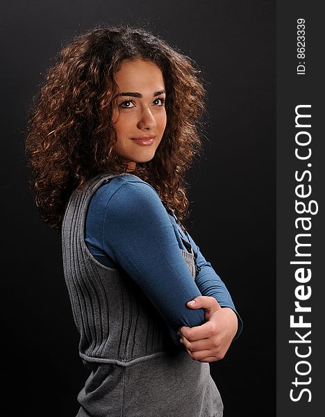 Beautiful model with curly hair over black