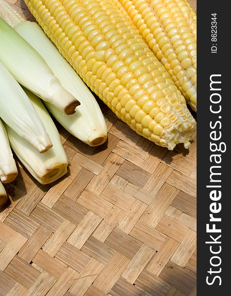 Variety of corn on traditional bamboo tray. Variety of corn on traditional bamboo tray
