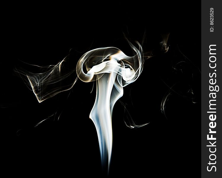 A photograph of smoke, isolated on a black background. A photograph of smoke, isolated on a black background.