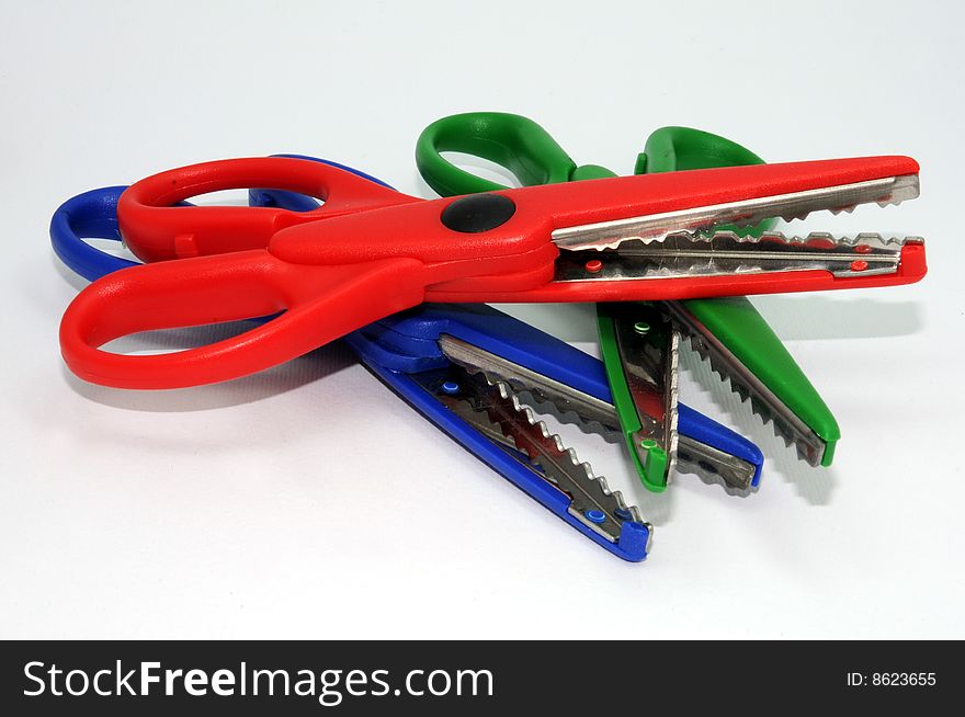 Red, blue & green serrated scissors. Red, blue & green serrated scissors