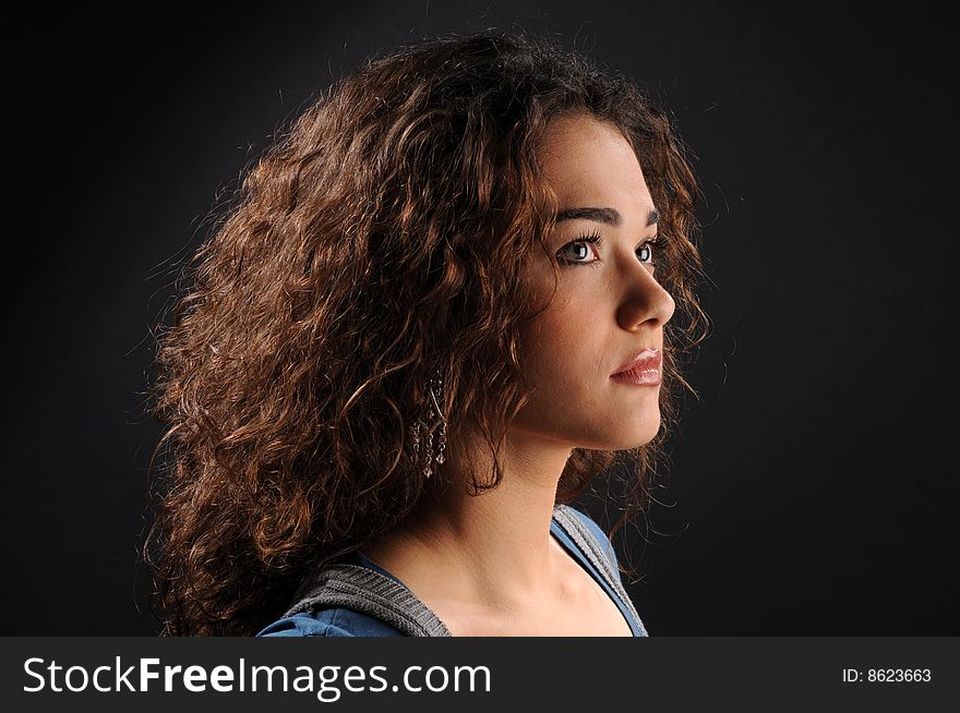 Beautiful model with curly hair over black