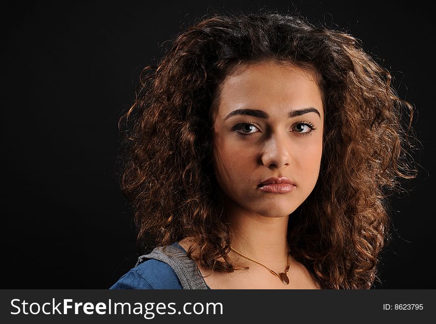 Young beautiful woman's portrait
over black