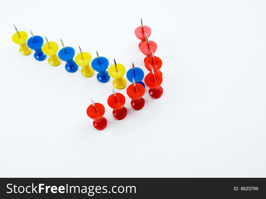 Arrow formation of push pins, showing a guidance or direction. Arrow formation of push pins, showing a guidance or direction