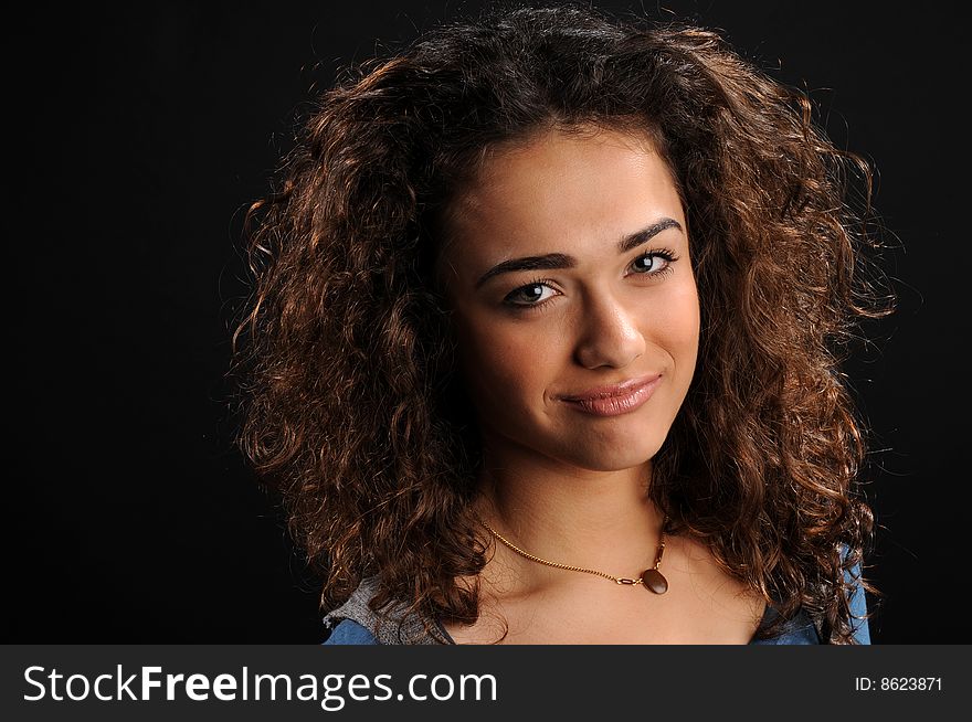 Beautiful model with curly hair over black