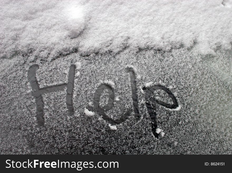Help written on snow covered table
