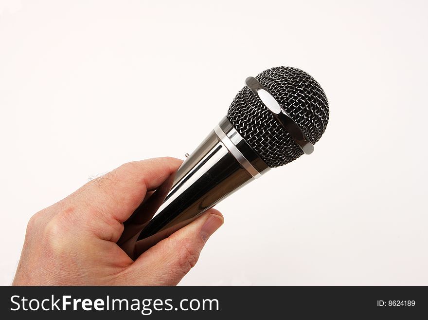Hand held microphone in use, over white. Hand held microphone in use, over white.