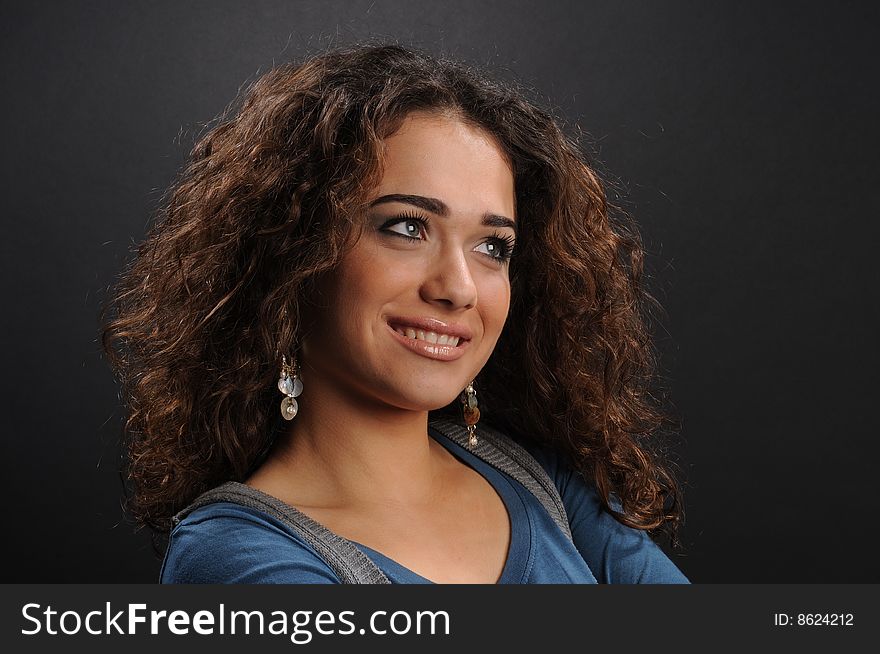 Beautiful model with curly hair over black