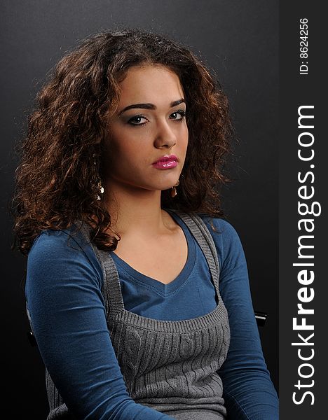 Beautiful model with curly hair over black