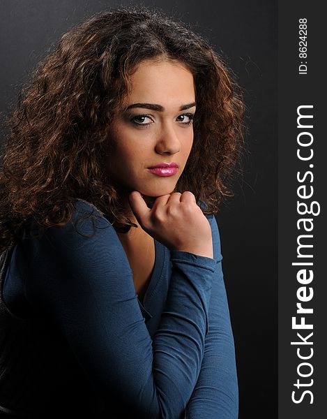 Beautiful model with curly hair over black