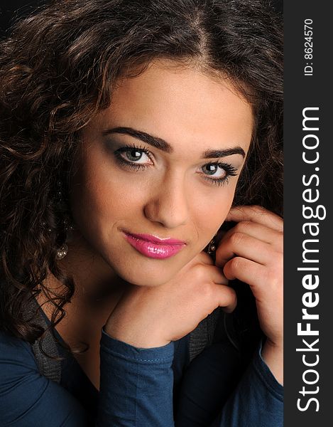 Beautiful model with curly hair over black