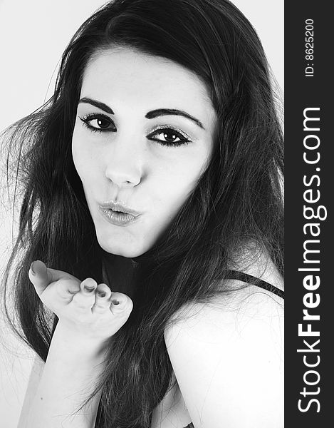 Female model head shot taken in studio altered to black and white for effect. model is blowing a kiss. Female model head shot taken in studio altered to black and white for effect. model is blowing a kiss.