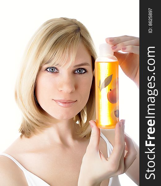 The beautiful blonde holds in hands a jar with perfumery. The beautiful blonde holds in hands a jar with perfumery