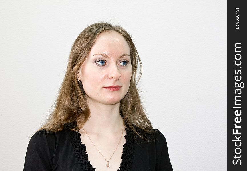 Girl in a black dress, on a white background, with an indifferent sight. Girl in a black dress, on a white background, with an indifferent sight.