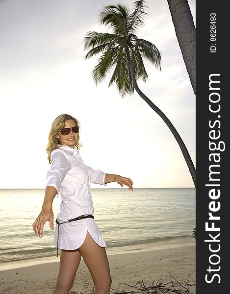 Beautiful woman is posing on the beach, on the maledives
