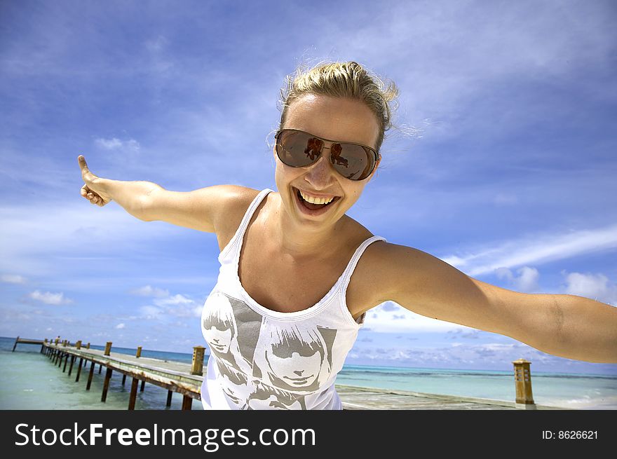 Beautiful woman is posing on the beach, on the maledives