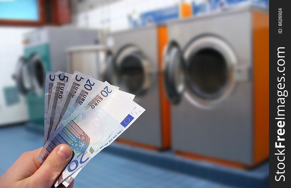 Laundering concept. Laundry room and money in hand.