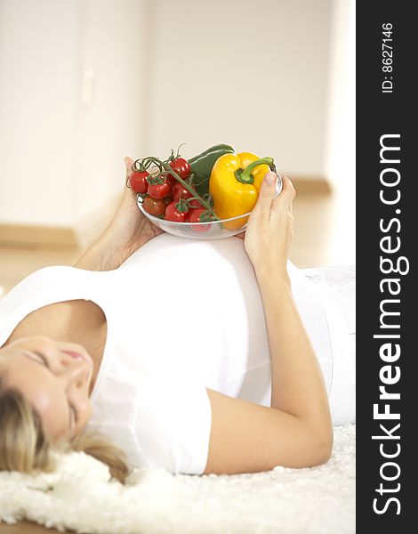 Young Pretty Pregnant Woman With Vegetables