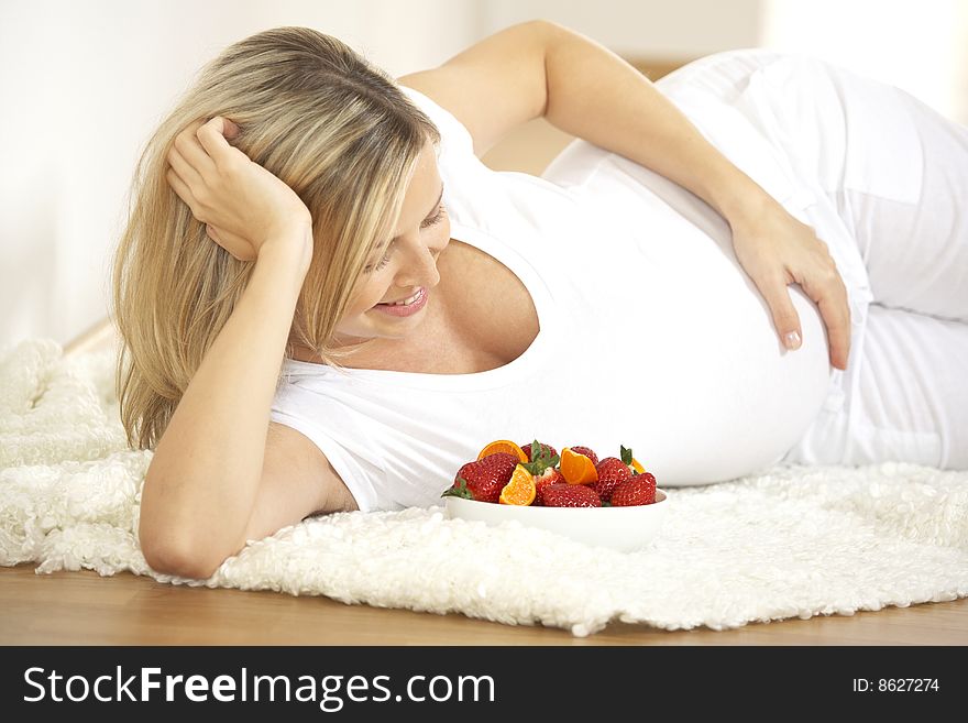 Young Pretty Pregnant Woman With Strawberries