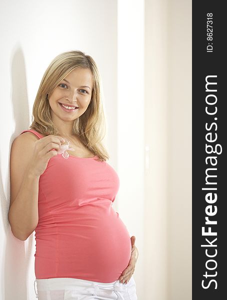 Young beautiful pregnant woman with dummy