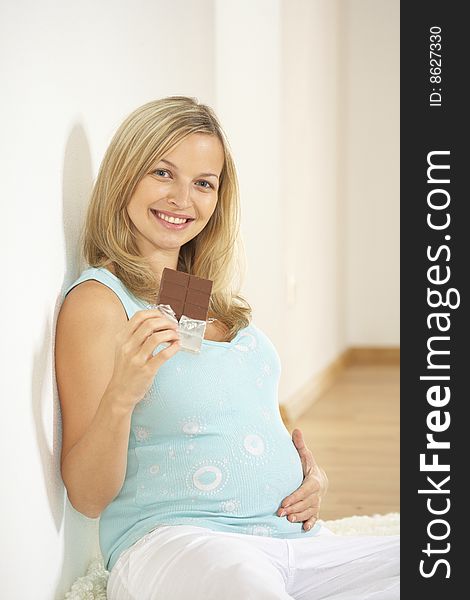 Young beautiful pregnant woman with chocolate