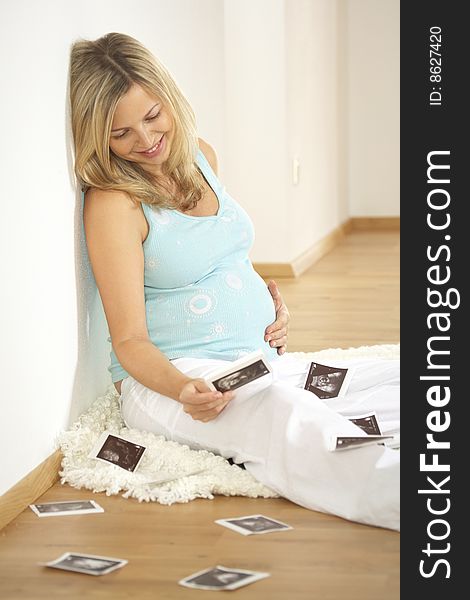 Beautiful pregnant woman with ultrasound pictures. Beautiful pregnant woman with ultrasound pictures