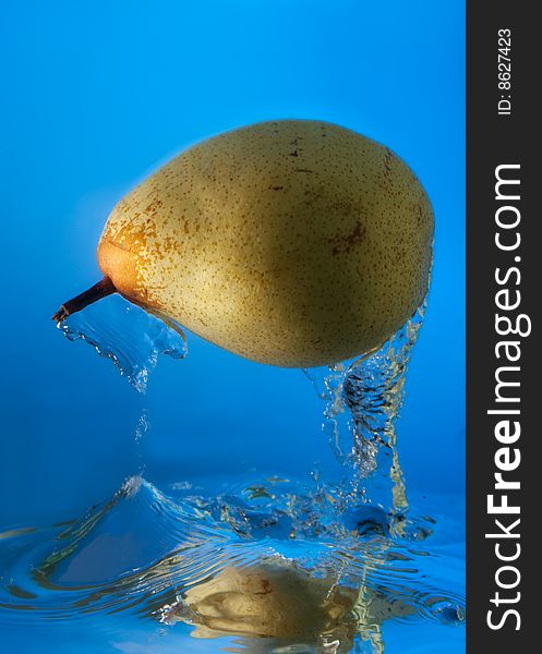 Pear in water on a blue background