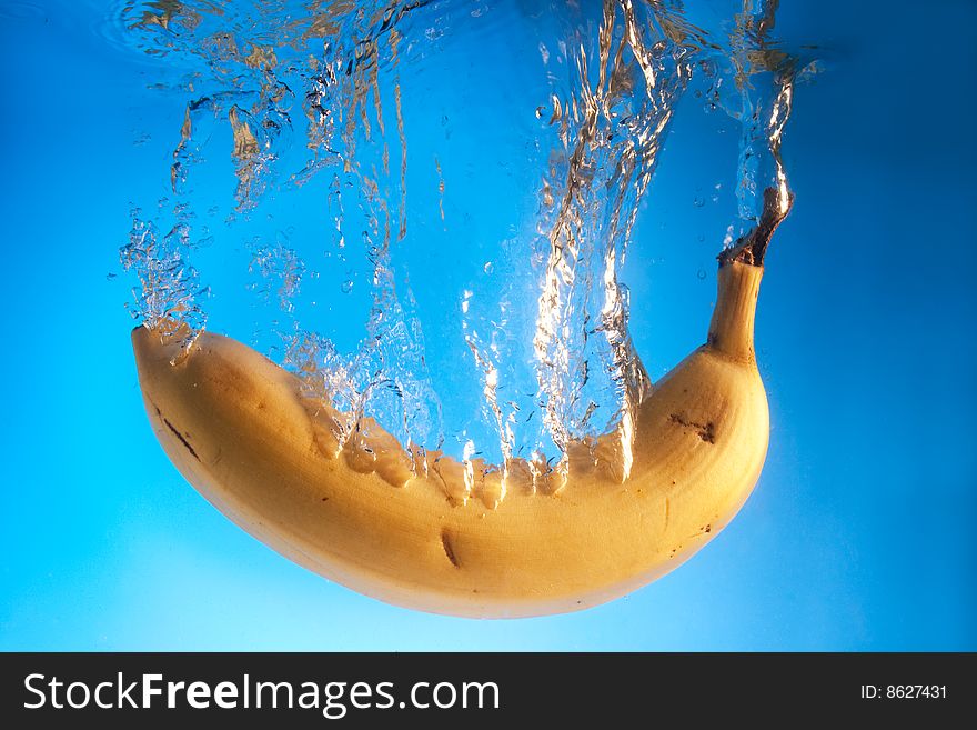 Banana in water on a blue background